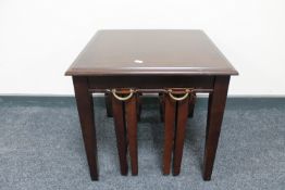 A mahogany lamp table fitted two tables beneath