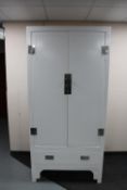 A contemporary white Chinese style double door wardrobe fitted a drawer