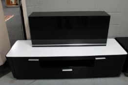 A contemporary black high gloss glass topped entertainment stand with matching wall cabinet