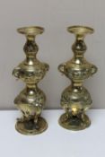 A pair of ornate brass eastern vases,