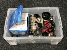 A box containing assorted fishing reels