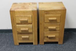 A pair of contemporary oak three drawer bedside chests