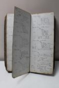 An antique hand-written doctor's ledger detailing medicine prices and buyers