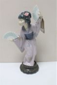 A Lladro figure of a geisha holding fans