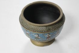 An early twentieth century cloisonne pot decorated with panels of eastern figures, height 11 cm.