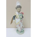 A Lladro figure of a girl in traditional Spanish dress with a bunch of flowers