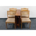 A 1970's teak G-Plan drop leaf table and four teak chairs