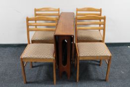A 1970's teak G-Plan drop leaf table and four teak chairs