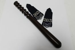 A 20th century turned wooden policeman's truncheon together with two epaulettes
