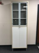 A contemporary Ikea double door display cabinet fitted cupboards beneath