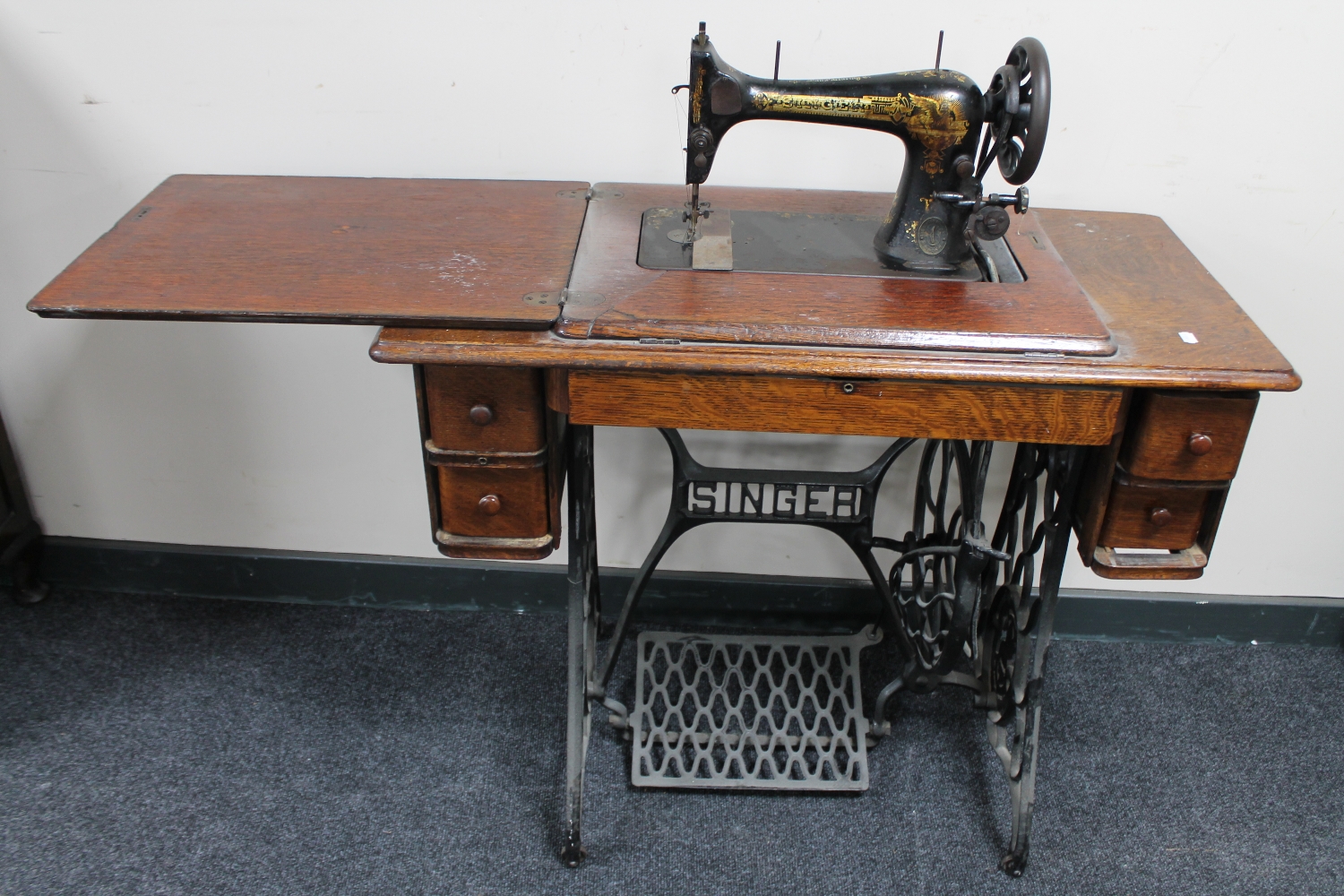 A Singer treadle sewing machine in oak table