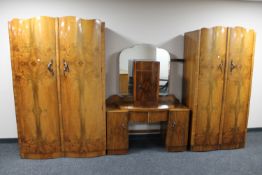 A five piece 1930's walnut bedroom suite comprising of lady's and gent's wardrobes,