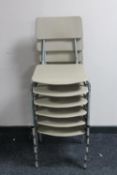 A set of six plastic 20th century stacking school chairs on metal legs
