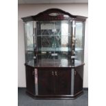 An Italianate high gloss four door display cabinet fitted with cupboards