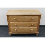 A stripped pine three drawer chest