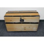 An early 20th century pine domed topped shipping trunk