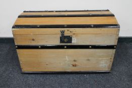 An early 20th century pine domed topped shipping trunk