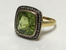 A 14ct gold large peridot and diamond cluster ring, size M.