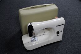 A cased Necchi electric sewing machine