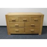 A contemporary oak seven drawer chest