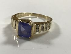 A 14ct gold diamond ring, set with a square cut blue stone (probably tanzanite), 4.5g, size M/N.