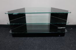 A contemporary three tier corner glass TV stand