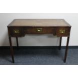 A mahogany ship's writing desk fitted three drawers and tooled leather inset panel