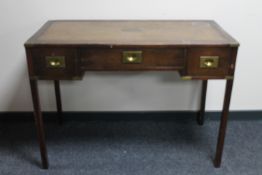 A mahogany ship's writing desk fitted three drawers and tooled leather inset panel