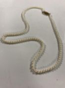 A cultured pearl necklace on 9ct gold clasp