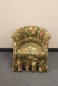 An early twentieth century tub chair upholstered in floral fabric