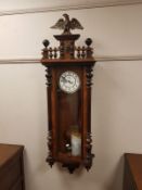 A Victorian walnut enamelled wall clock with eagle pediment,