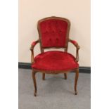 A continental beech framed salon armchair upholstered in red dralon
