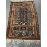 A fringed Persian rug on brown ground