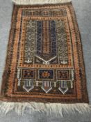 A fringed Persian rug on brown ground