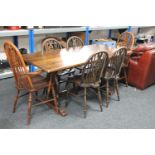 An oak refectory dining table and six Windsor style chairs