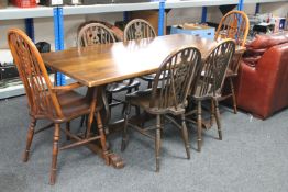 An oak refectory dining table and six Windsor style chairs