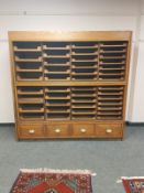 An early 20th century haberdashery chest fitted forty-four pull out drawers and four drawers