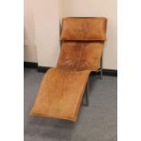 A twentieth century brown leather relaxer chair on metal base