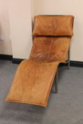 A twentieth century brown leather relaxer chair on metal base
