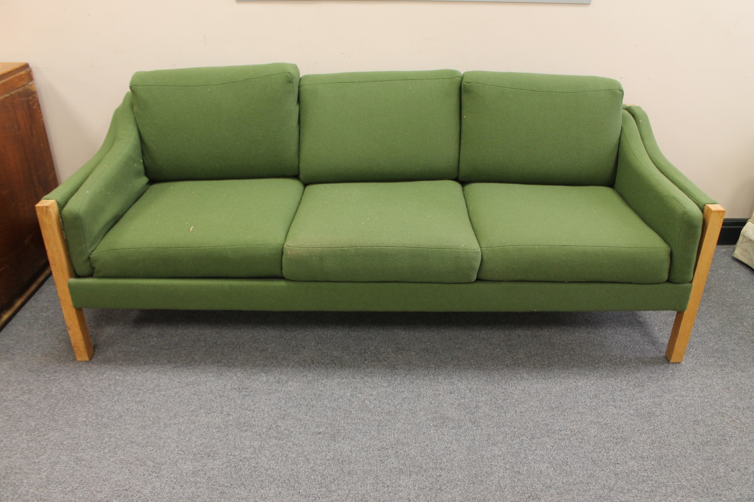 A twentieth century blond oak framed three seater settee upholstered in green fabric
