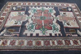 A fringed woolen Eastern rug of geometric design on cream ground, 320cm by 230cm.