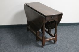 A Victorian oak gate leg table
