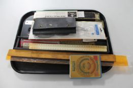 A tray of drawing instruments, rulers,