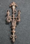 A gilt composite ornate two-way wall candelabra