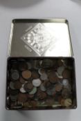 An Ambela confectionary tin containing British George V & VI and foreign coins