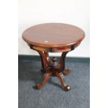 A circular Eastern mahogany occasional pedestal table