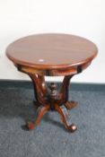 A circular Eastern mahogany occasional pedestal table