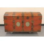 An antique metal bound domed shipping trunk with metal handles