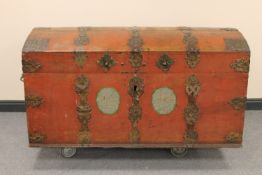 An antique metal bound domed shipping trunk with metal handles