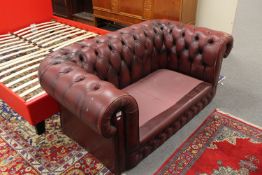 Two seater red leather Chesterfield settee (no cushions)